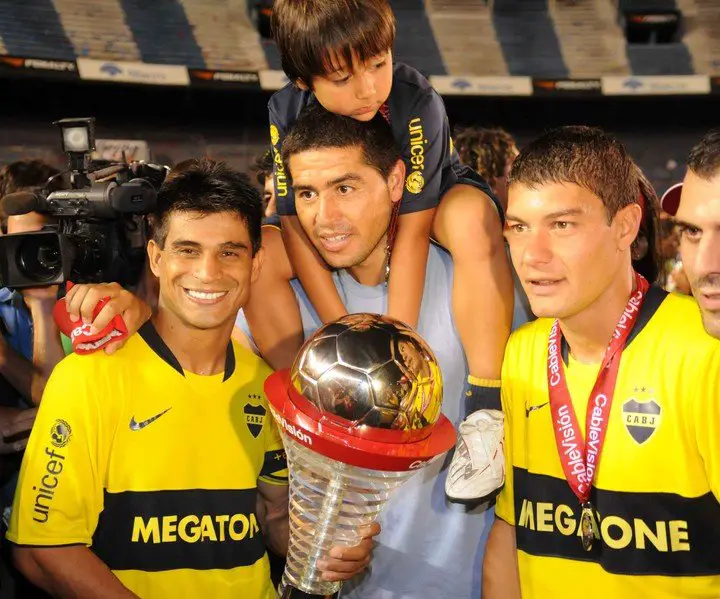 Hugo Ibarra, Juan Román con su hijo a cococho y Battaglia, todos celebrando el Apertura 08 (Jorge Sánchez/Archivo).