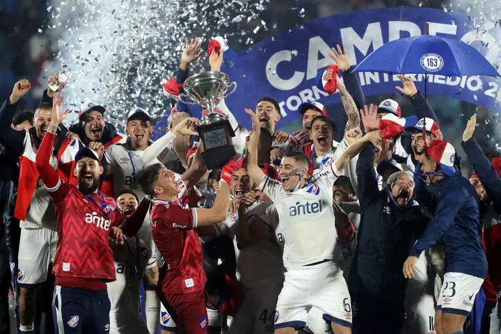 Jugadores de Nacional celebran con el trofeo al ganar la final del Torneo Intermedio 2022. (EFE)